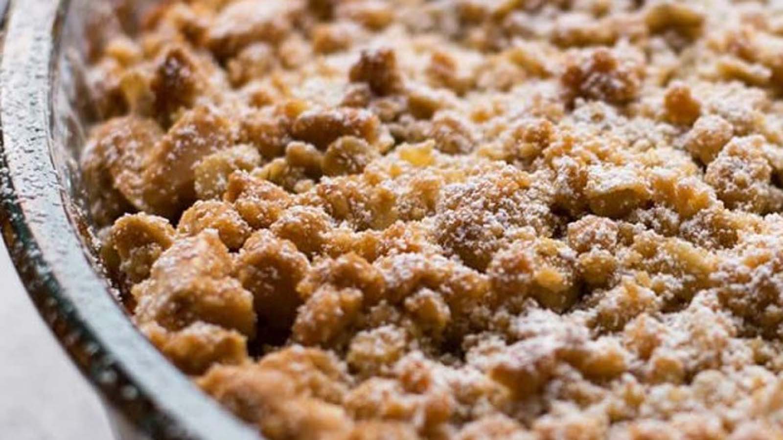 A warm baked apple crumble dessert with a golden, buttery oat topping.