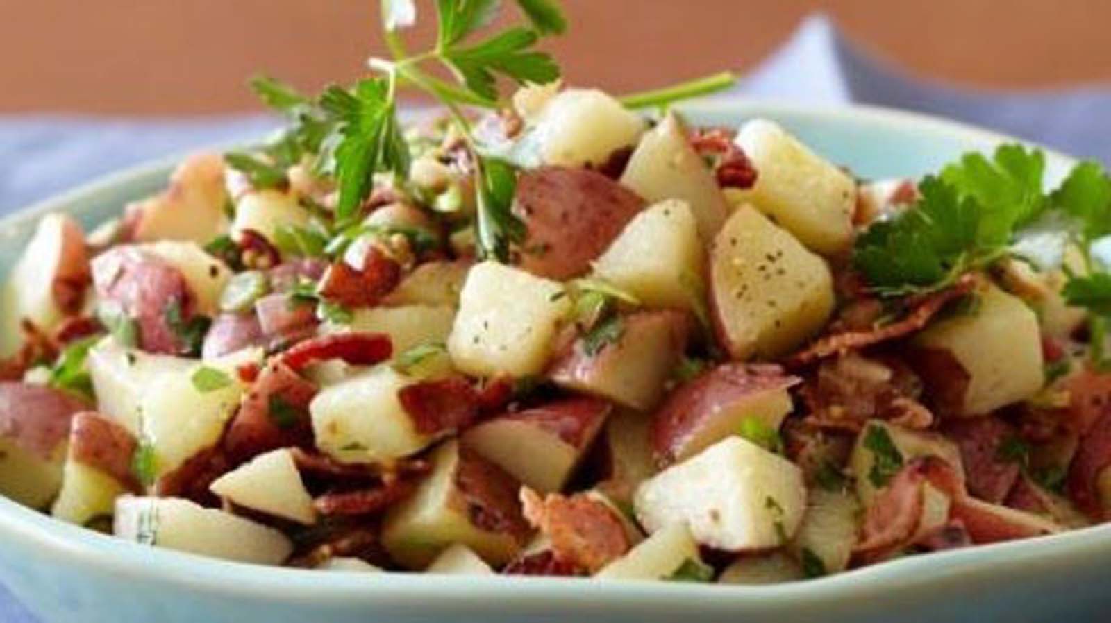 Uschi''s classic creamy potato salad mixed with fresh herbs and mayonnaise for a braai.