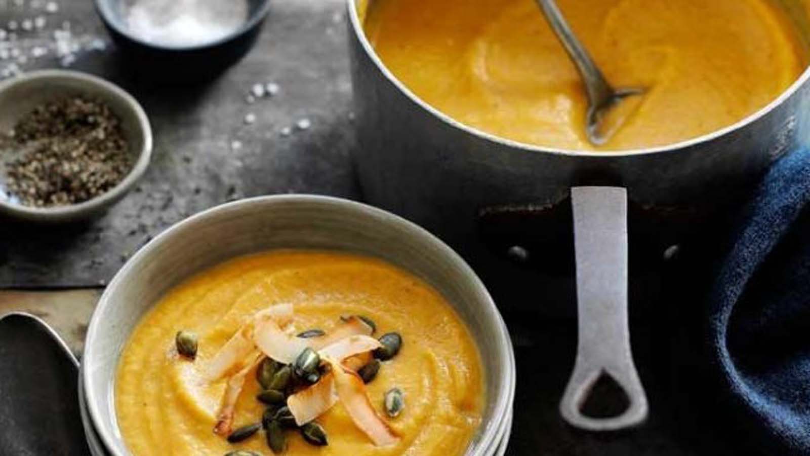 A silky smooth, vibrant orange roasted butternut soup in a ceramic bowl.