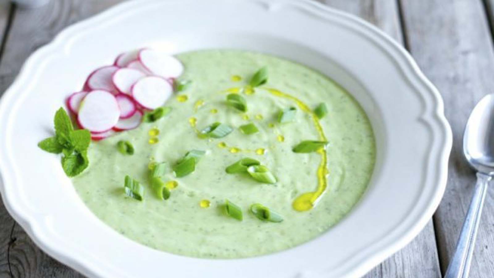 Chilled and refreshing cold cucumber and mint soup served in a porcelain bowl.