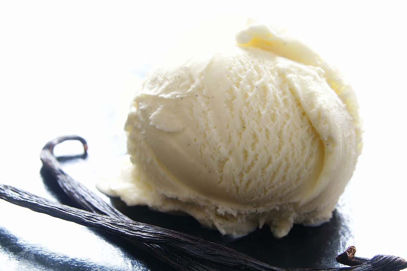 Creamy, scoopable homemade vanilla ice cream showing a smooth and rich texture.