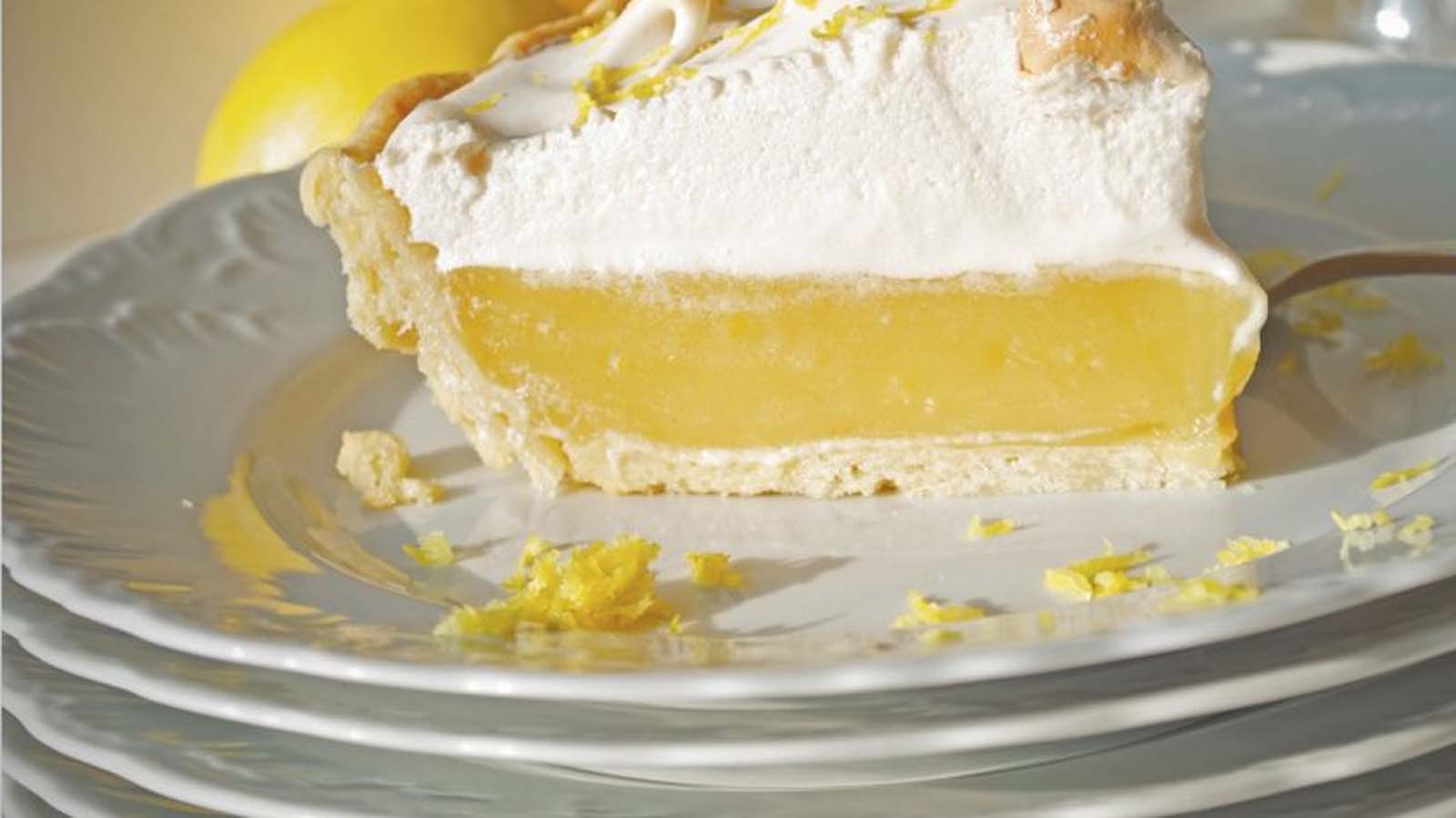 A stunning lemon meringue pie with high peaks of toasted golden meringue topping.