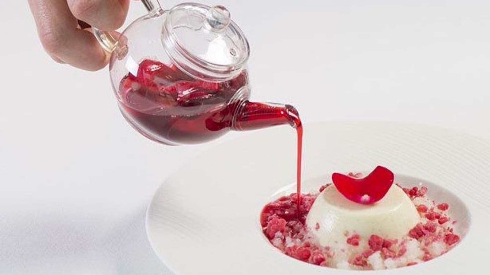 Festive creamy raspberry Christmas panna cotta topped with fresh red berries and syrup.