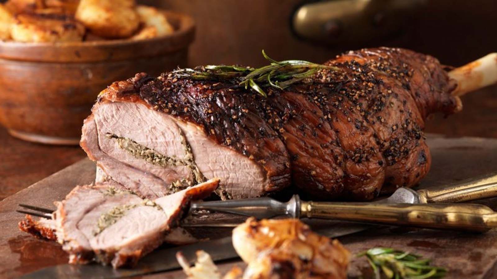 A succulent holiday roast lamb leg seasoned with herbs and cooked until tender.