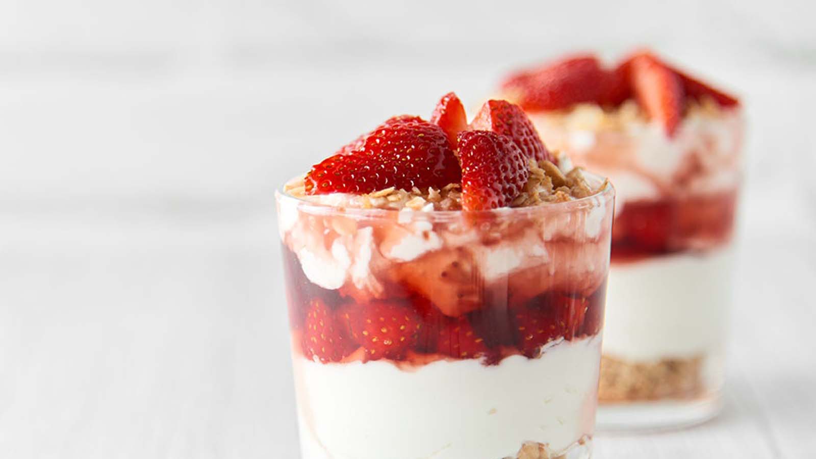 A beautiful layered summer berry Christmas trifle dessert in a large glass bowl.