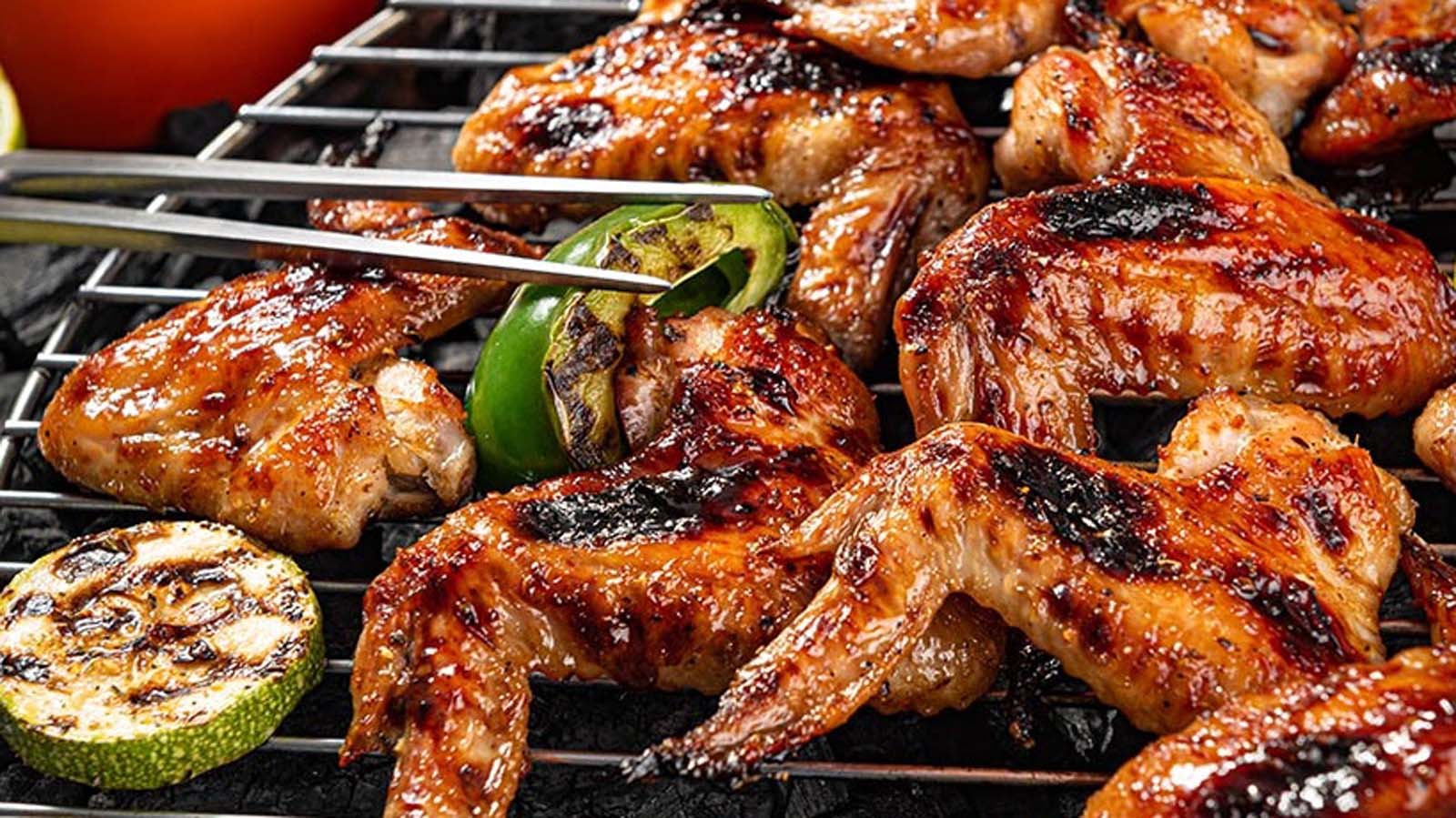 Succulent pieces of slow-smoked BBQ meat cooked to absolute perfection on a Weber grill.