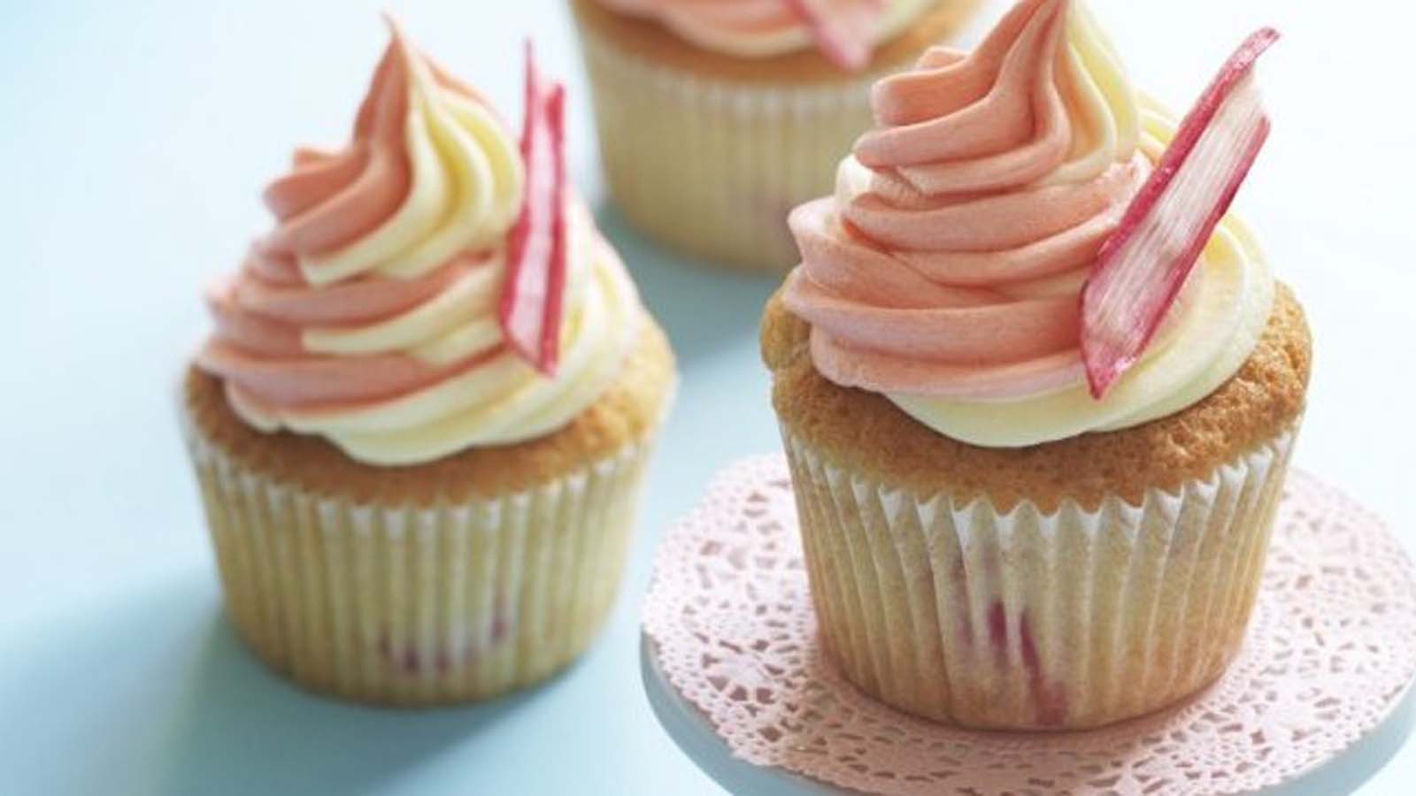 Classic vanilla cupcakes decorated with smooth vanilla buttercream frosting and sprinkles.