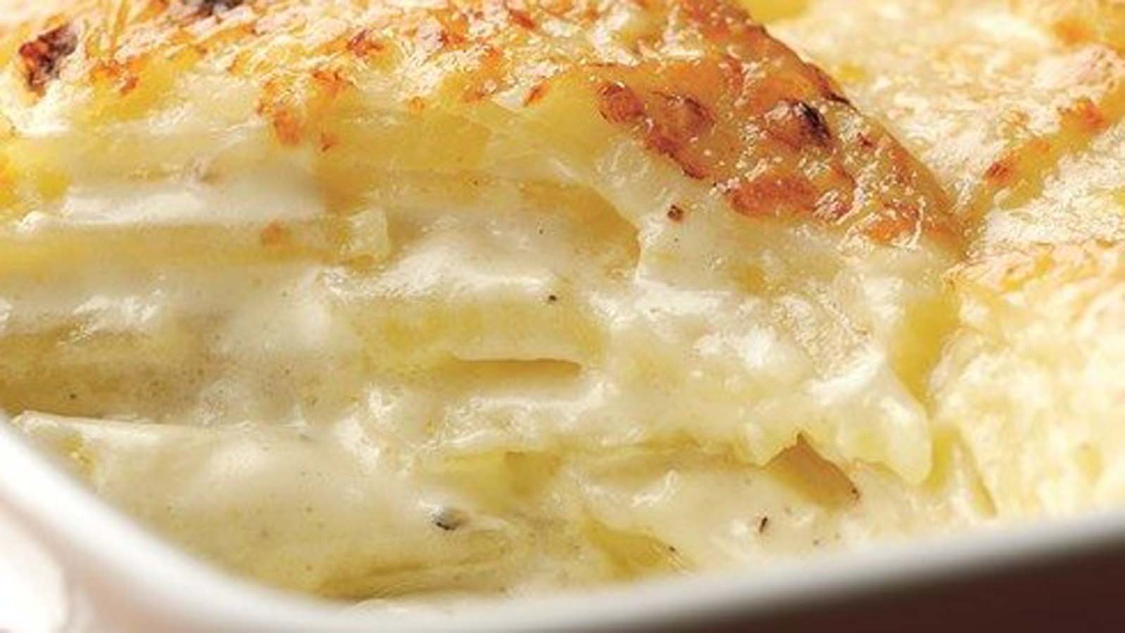 A warm, cheesy potato bake bubbling with fresh cream and a golden browned top crust.