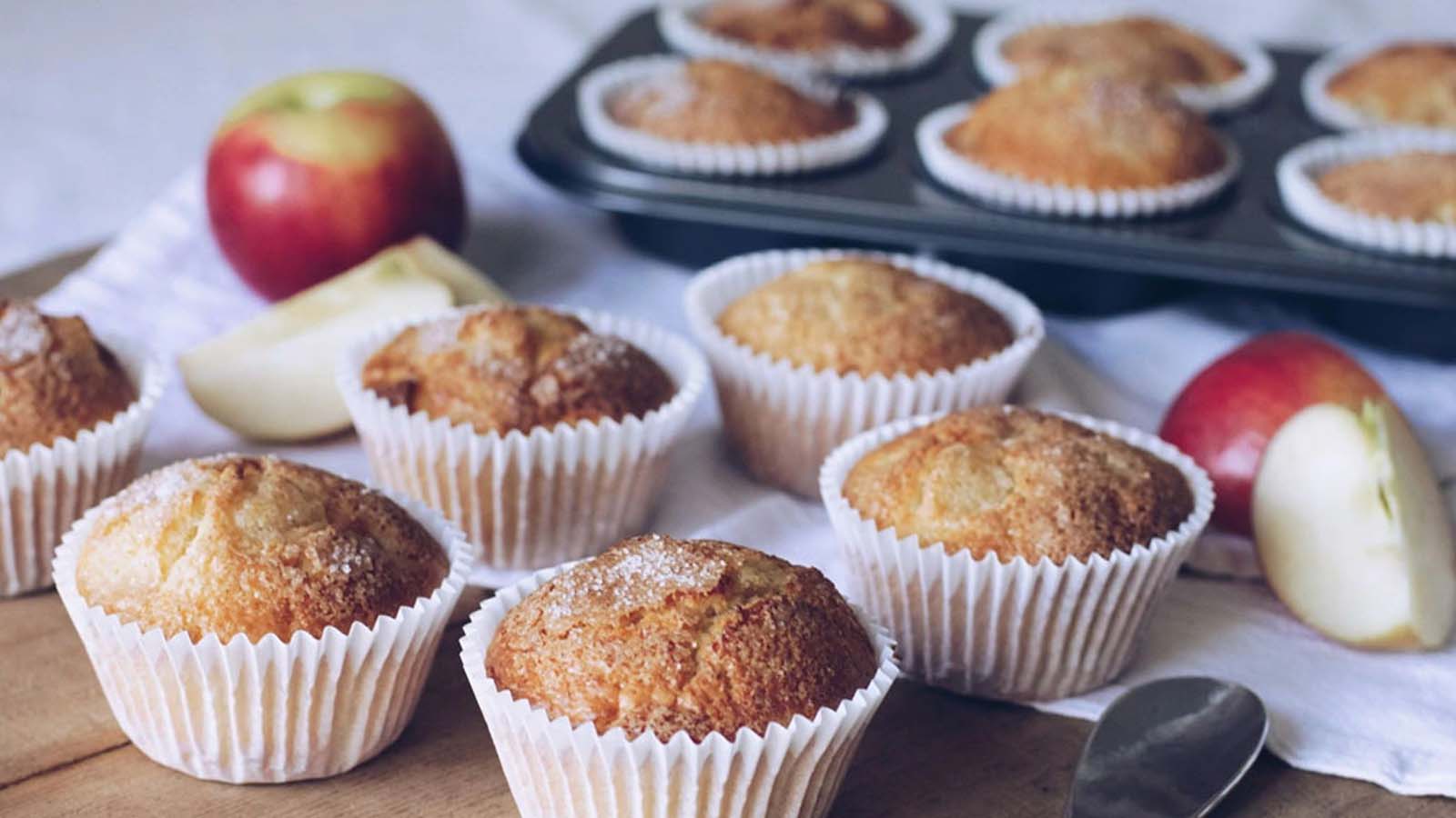 Freshly baked apple muffins flavoured with ginger and cinnamon, dusted with sugar.