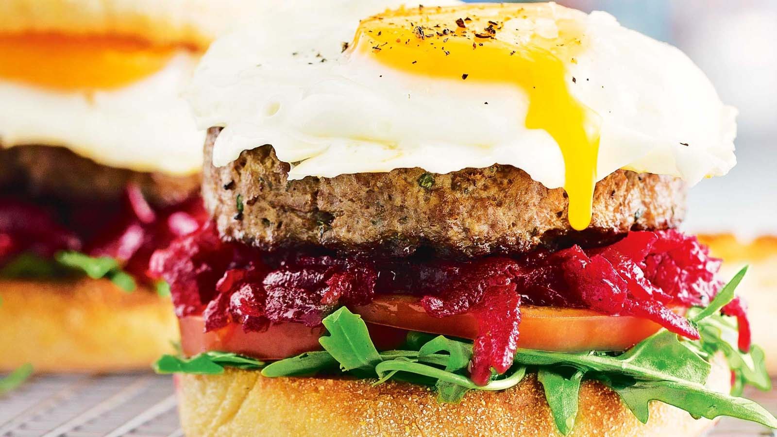A massive classic Aussie beef burger stacked high with egg, beetroot, beef patty, and cheese.