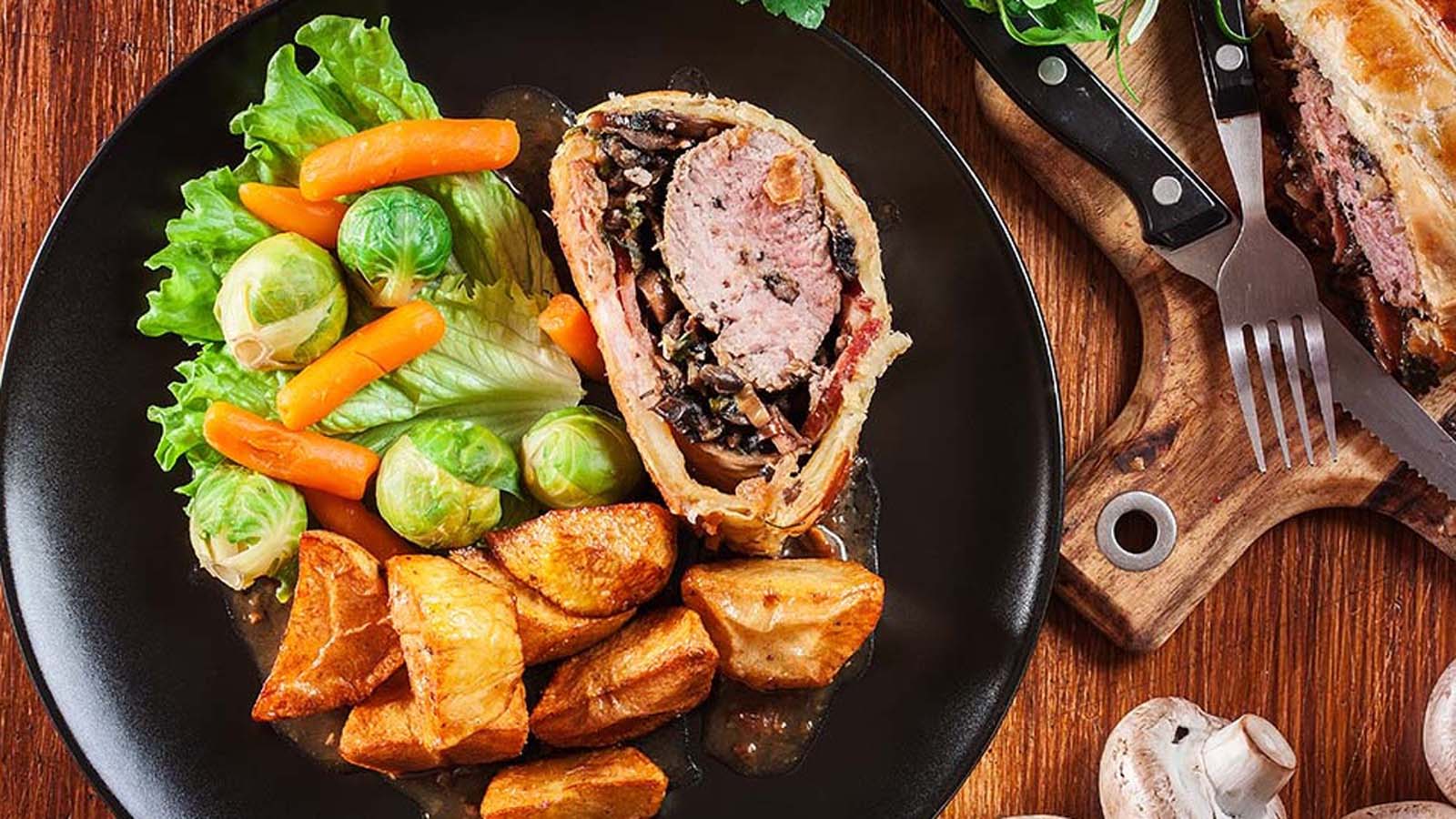An exquisite classic beef wellington steak wrapped in mushroom duxelles and golden puff pastry.