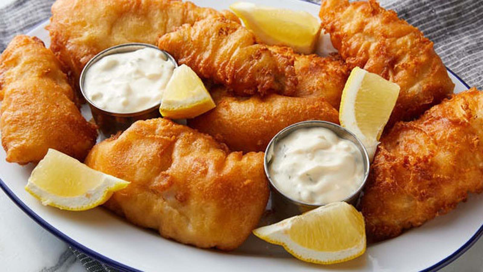 Crispy golden beer-battered fish fillets served with hot chips.