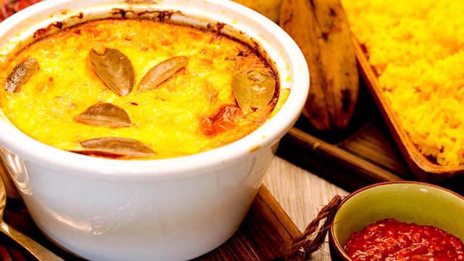Traditional South African baked savoury minced beef Bobotie served with bright yellow turmeric rice.