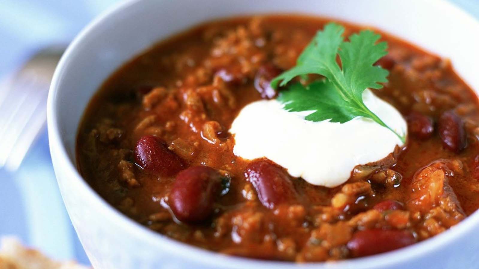 A deep bowl of hearty, spicy tex-mex chili con carne minced beef stew with beans.