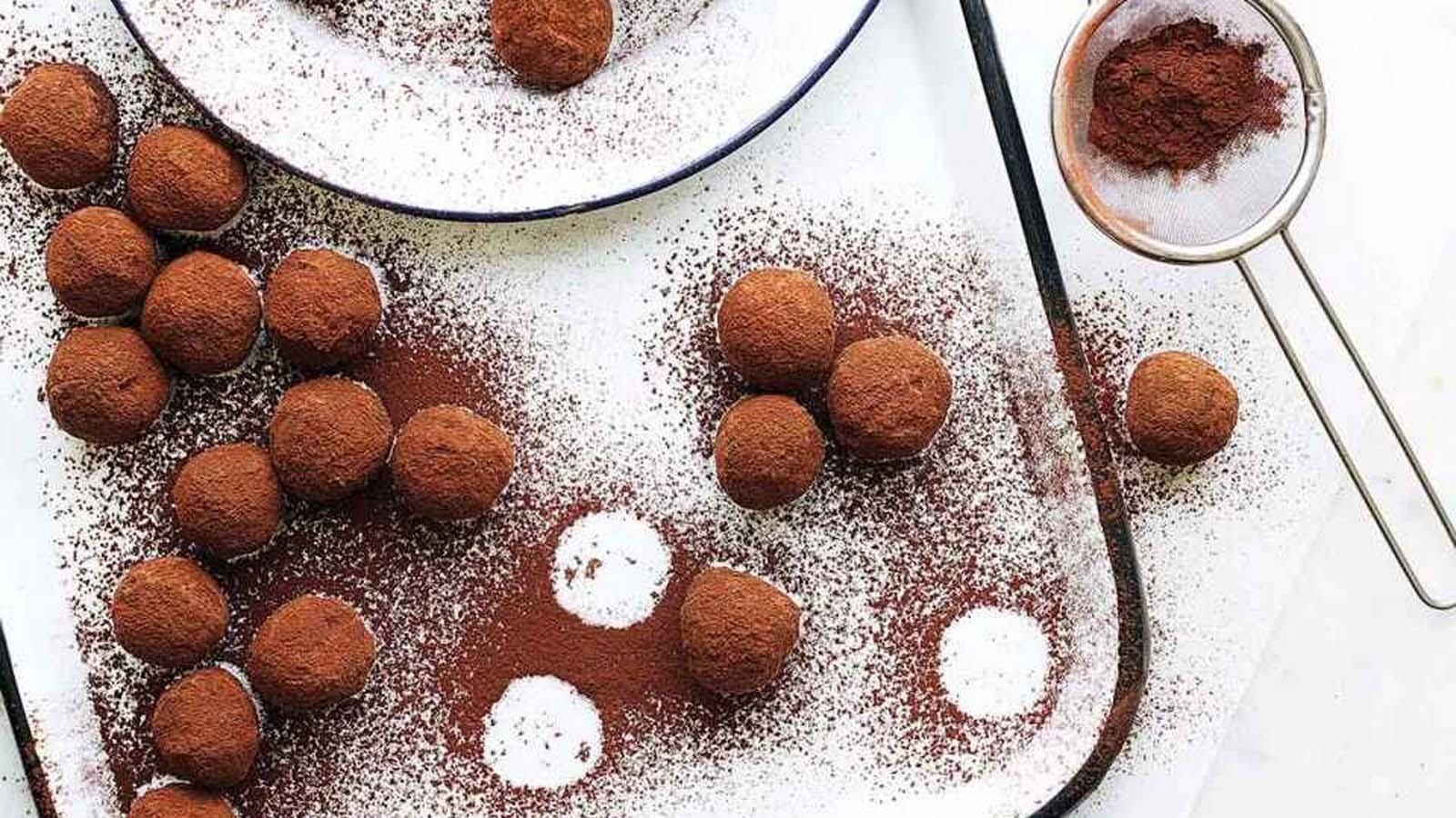 A luxury box of rich, dark chocolate truffles dusted beautifully in cocoa powder.