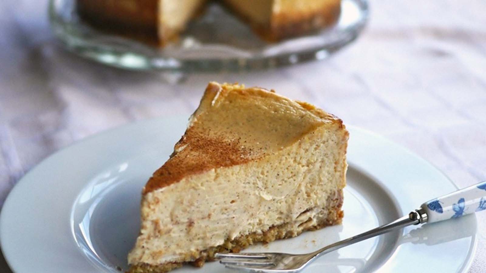 A delicious slice of baked cinnamon cheesecake with a spiced graham cracker crust base.