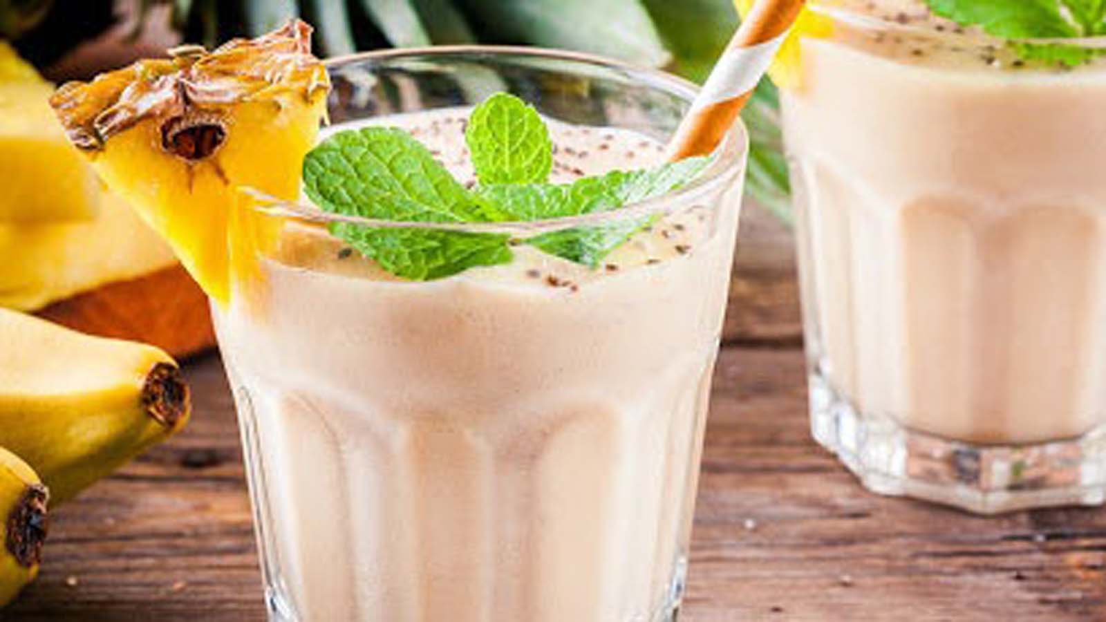 A refreshing, thick blended white coconut smoothie garnish with shredded coconut flakes.