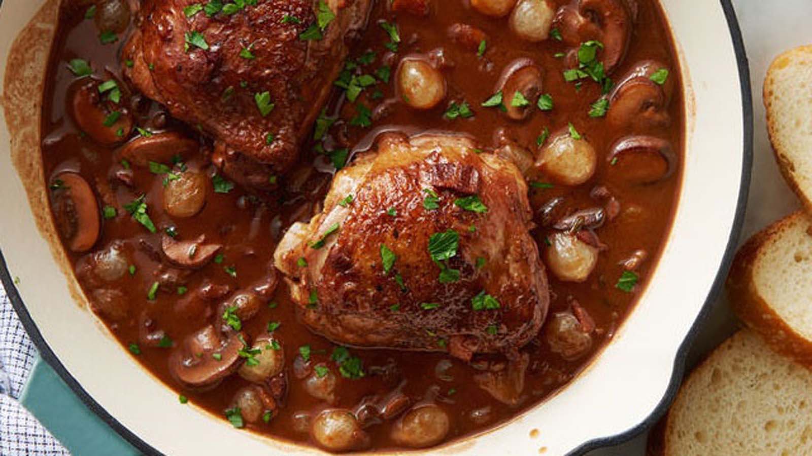 A traditional French coq au vin chicken stew braised in rich red wine sauce.
