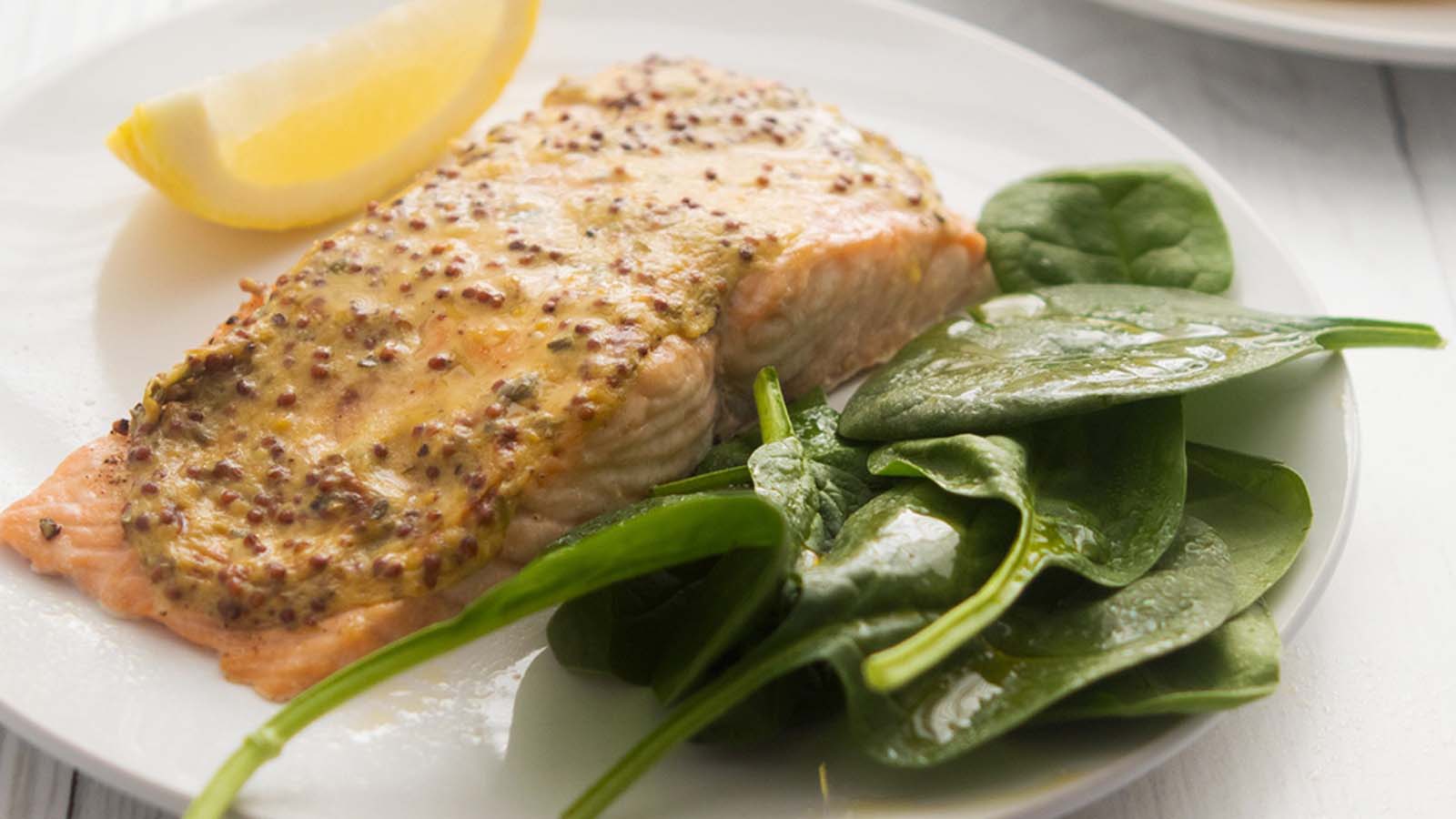 A rich and savoury creamy wholegrain mustard steak sauce showing textured mustard seeds.