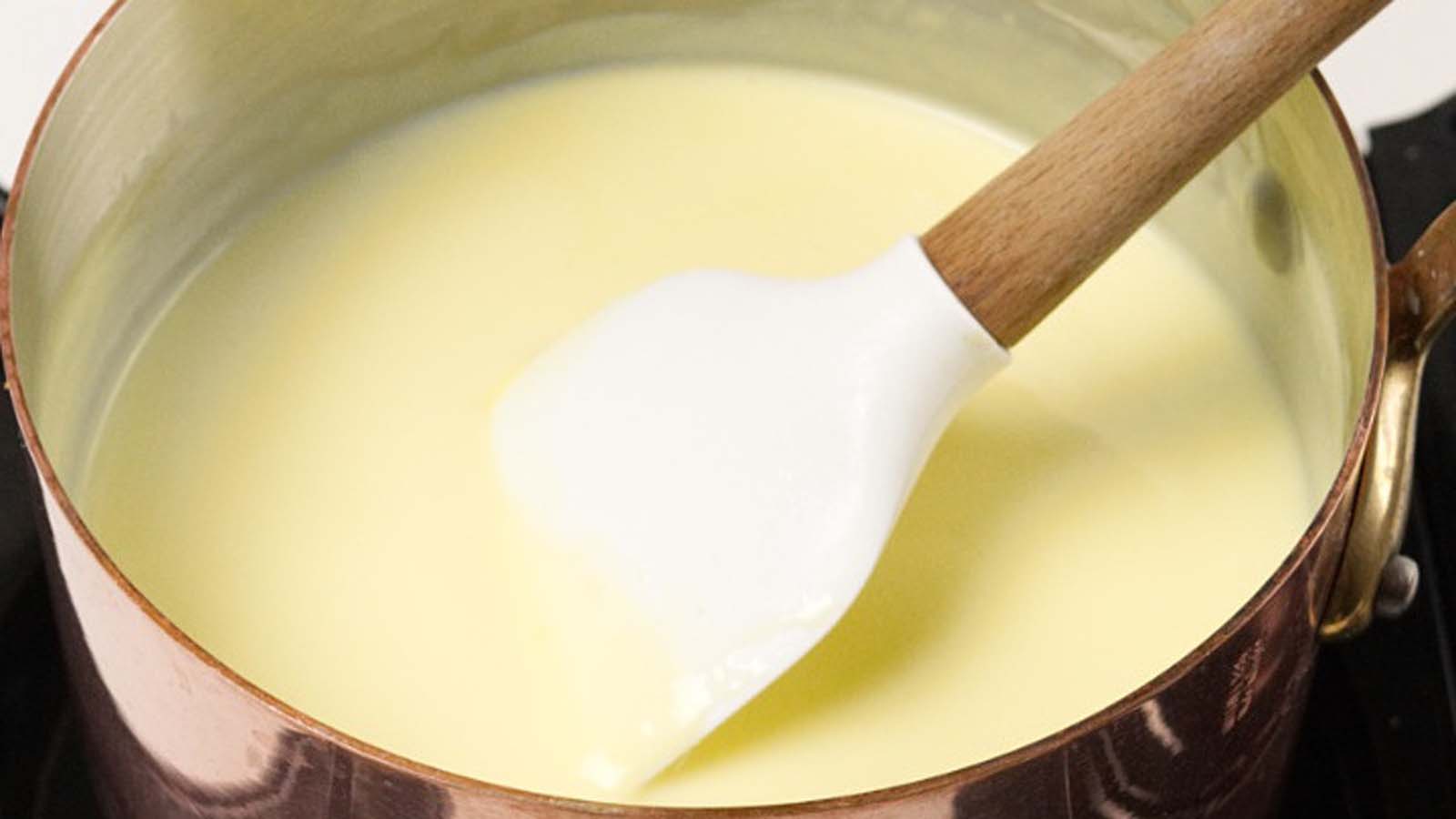 A smooth, creamy yellow pourable creme anglaise vanilla custard sauce.