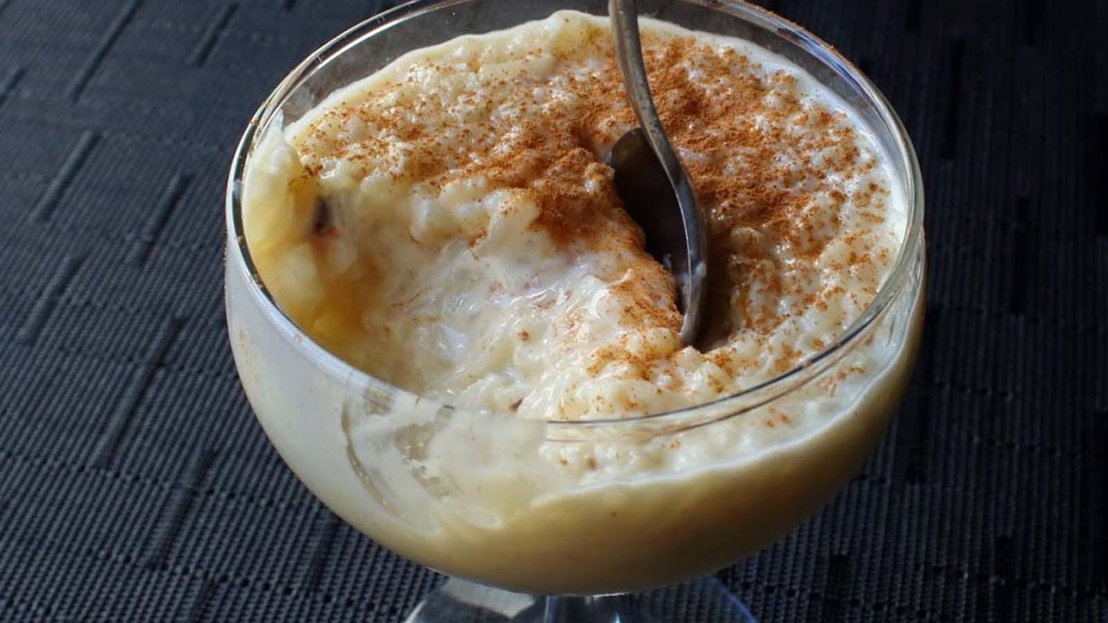 A comforting bowl of old-fashioned baked English rice pudding dusted with nutmeg.