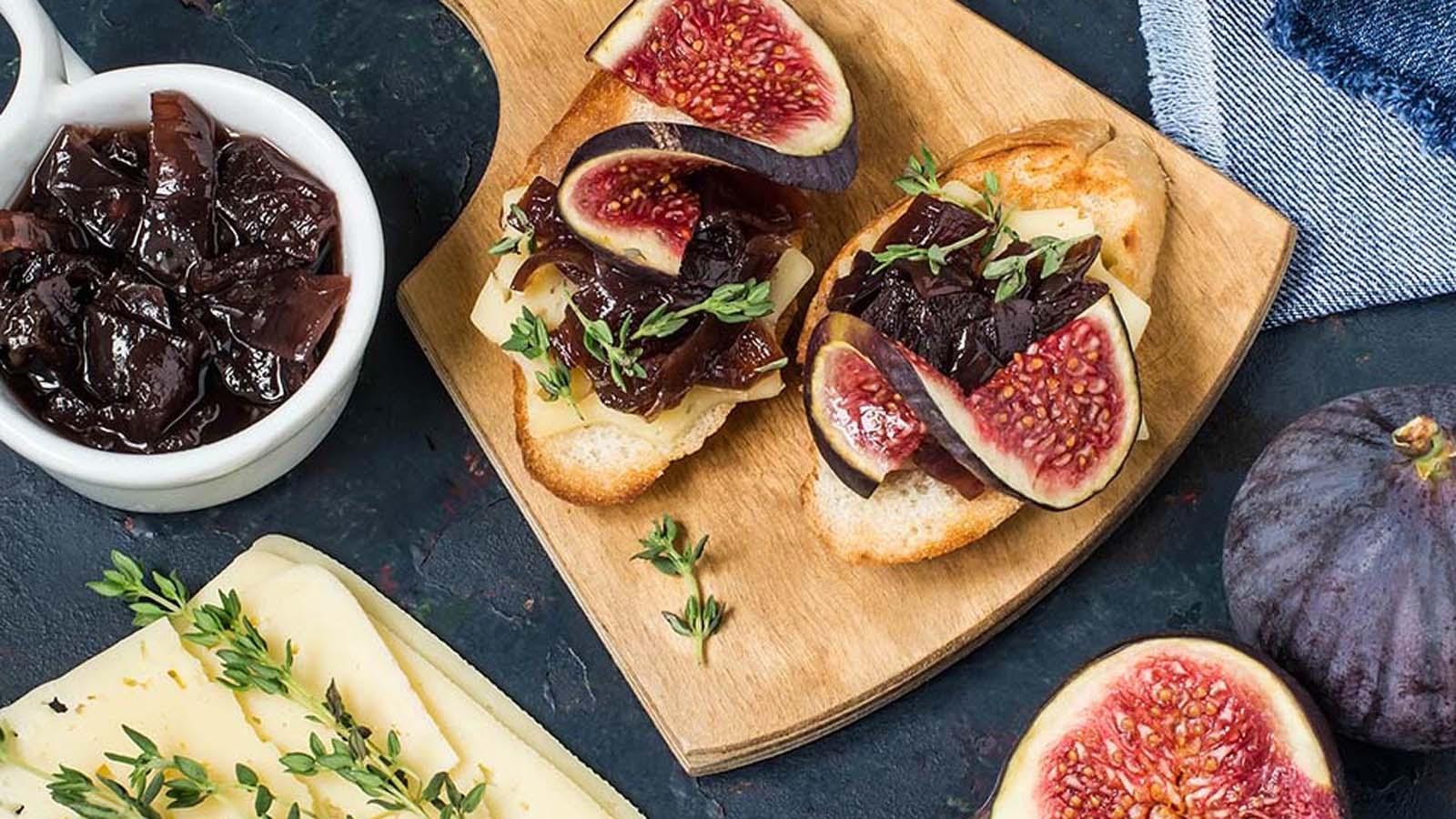 A clear jar of rich, thick sweet homemade fig jam preserve showing seeded textures.