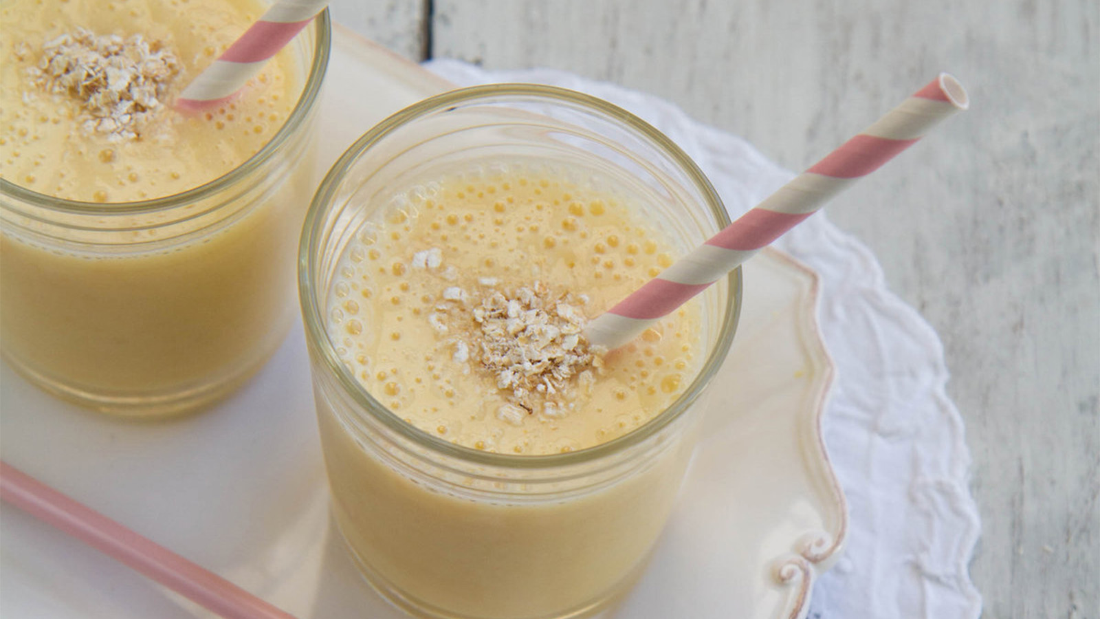 A colorful mixed fruit smoothie drink showing layers of blended tropical fruits.