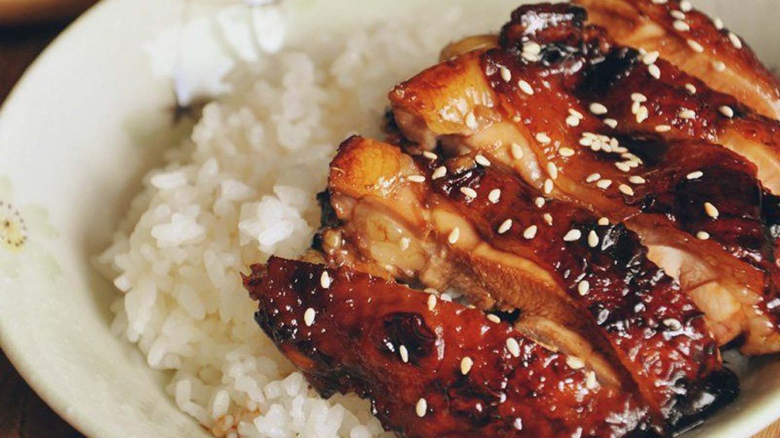 A thick, glossy dark brown homemade teriyaki glaze sauce in a bowl.