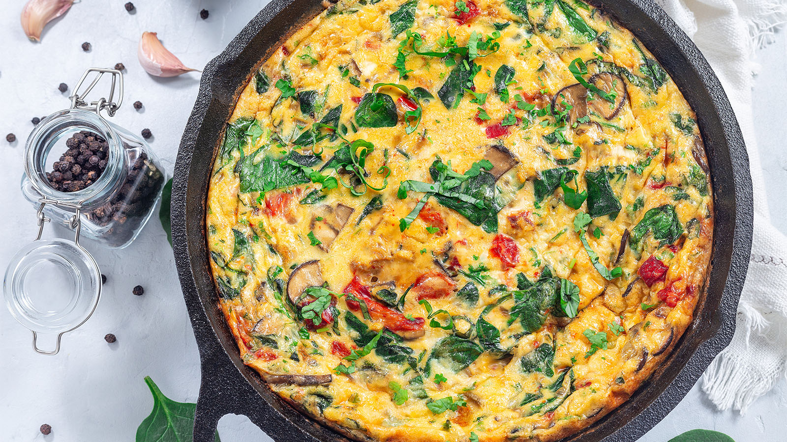 A perfectly folded breakfast omelet filled with earthy sautéed mushrooms and cheddar cheese.