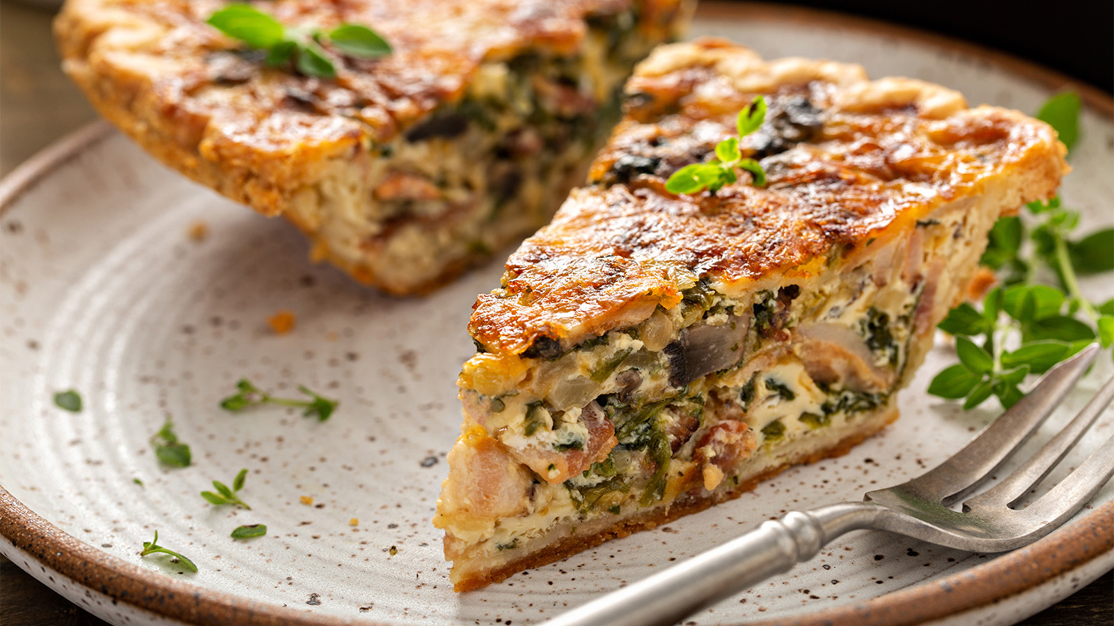 A delicious quiche featuring earthy sautéed mushrooms, sweet onion marmalade, and melted cheese.
