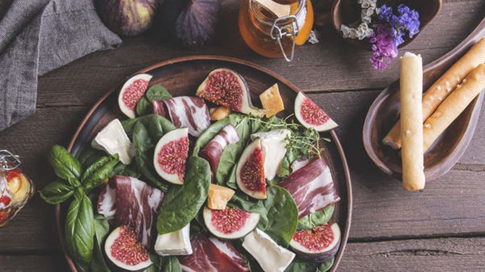 An elegant salad of cured Parma ham, sweet figs, and soft bocconcini mozzarella balls.