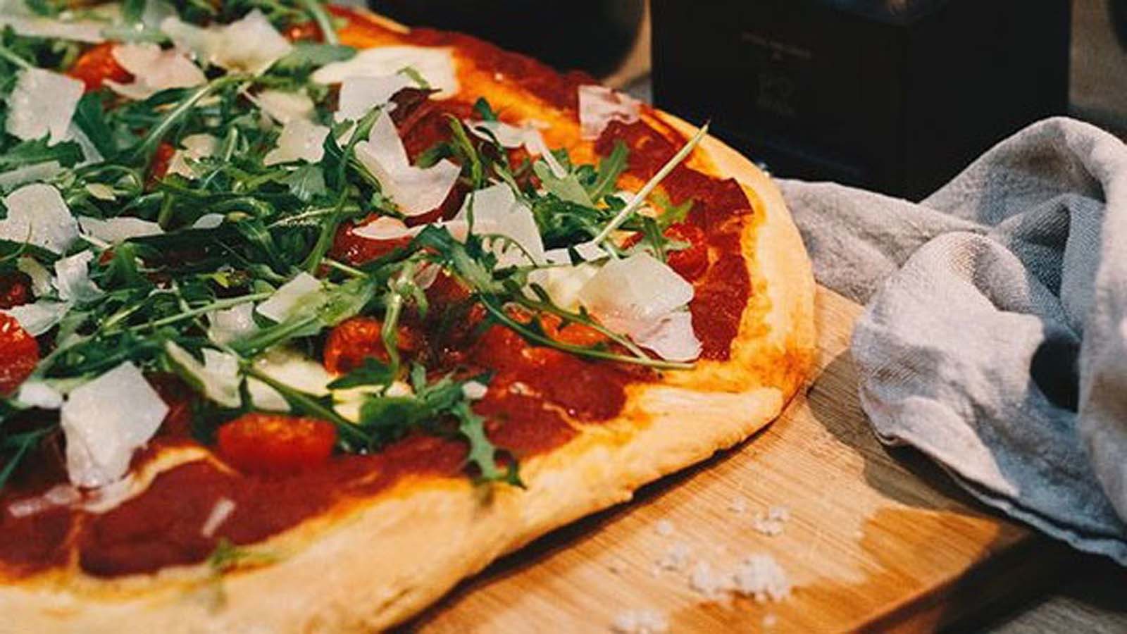 A freshly kneaded, round and soft pizza base dough ready for toppings.