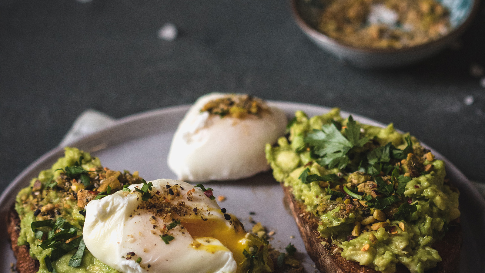 A perfectly poached egg served over a bed of sautéed wild mushrooms and green spinach.