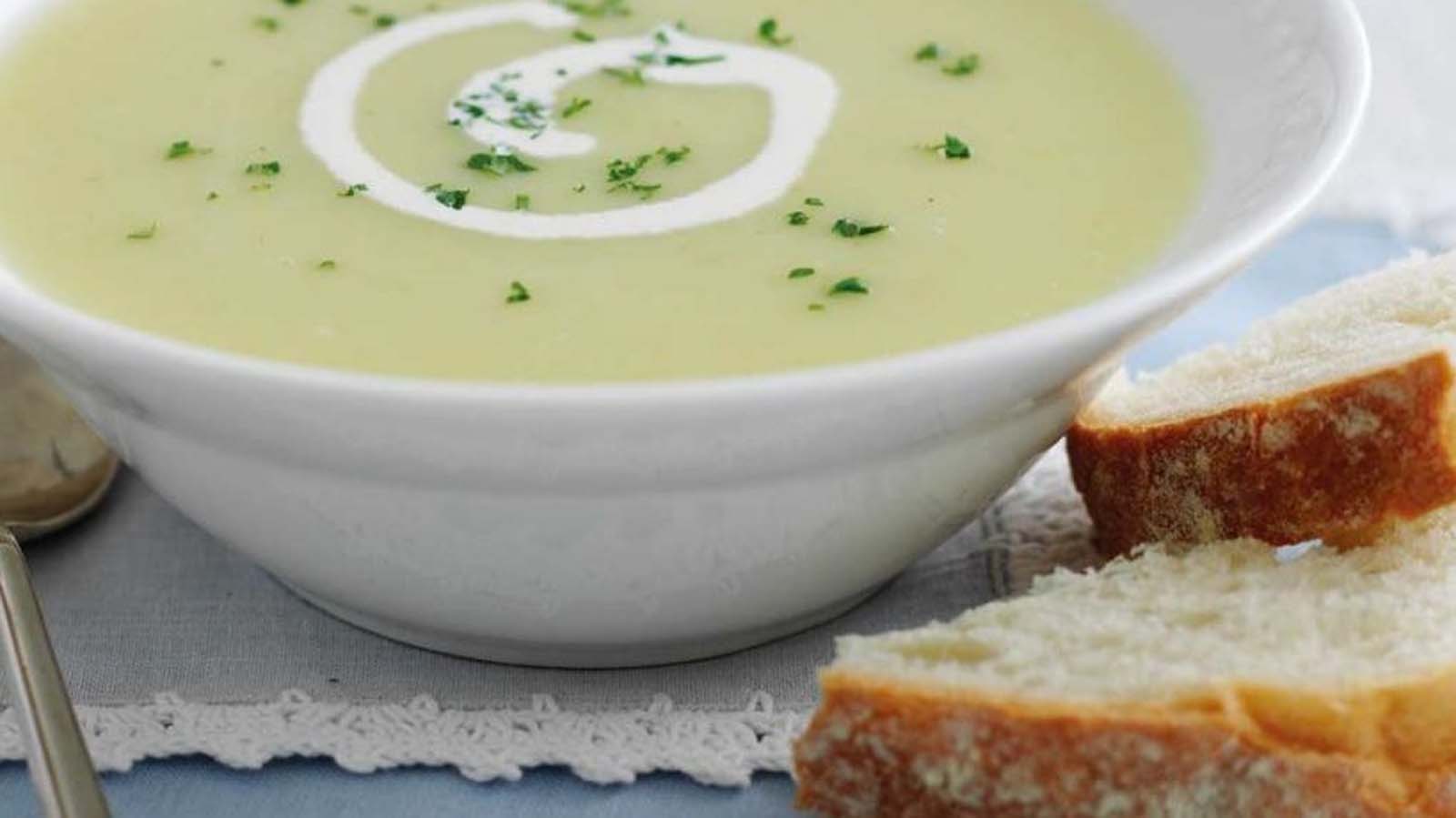 A thick, comforting creamy potato and leek soup garnished with fresh chives.