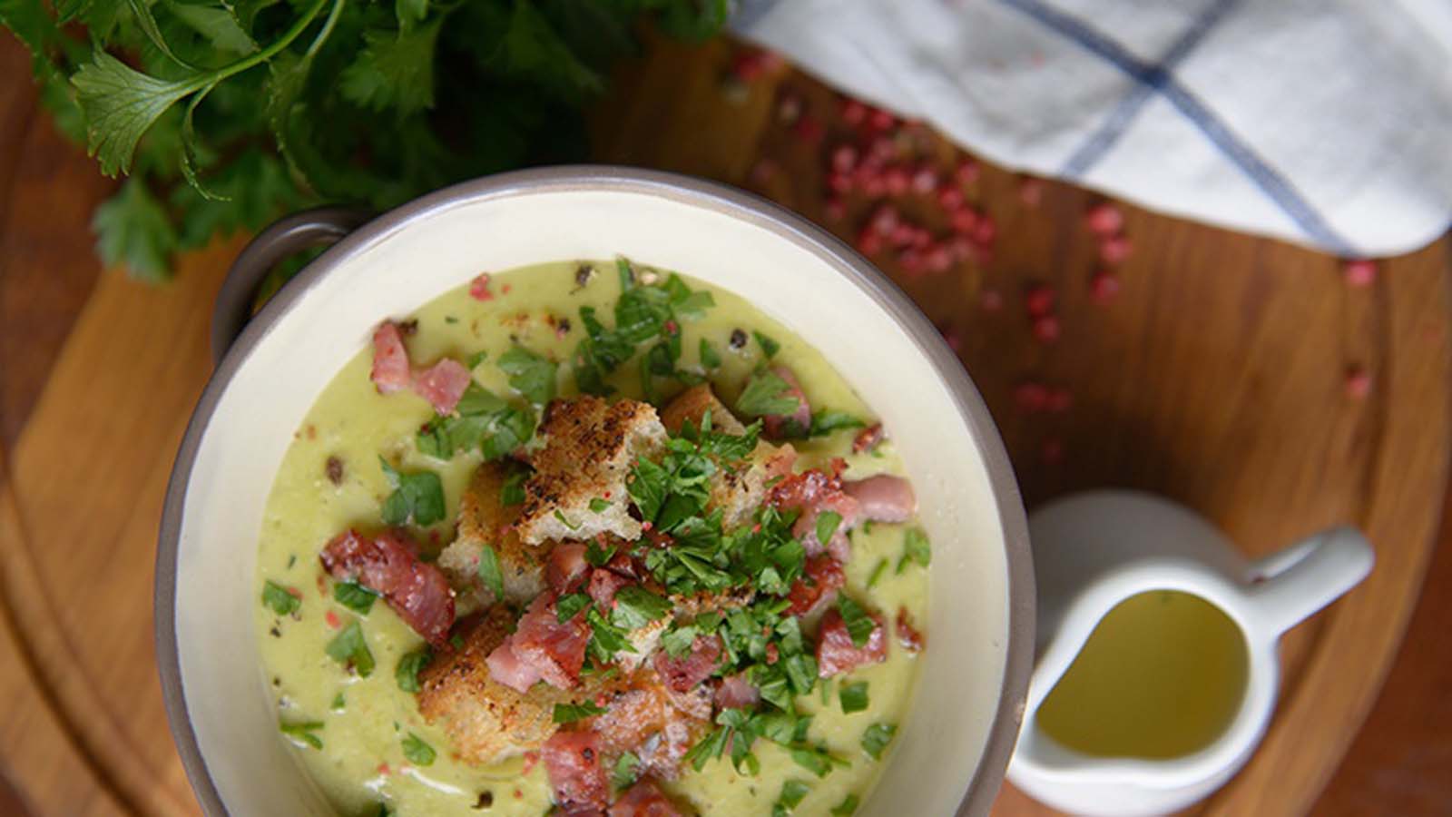 A deep bowl of quick and easy creamy chicken bacon gnocchi soup served hot with herbs.