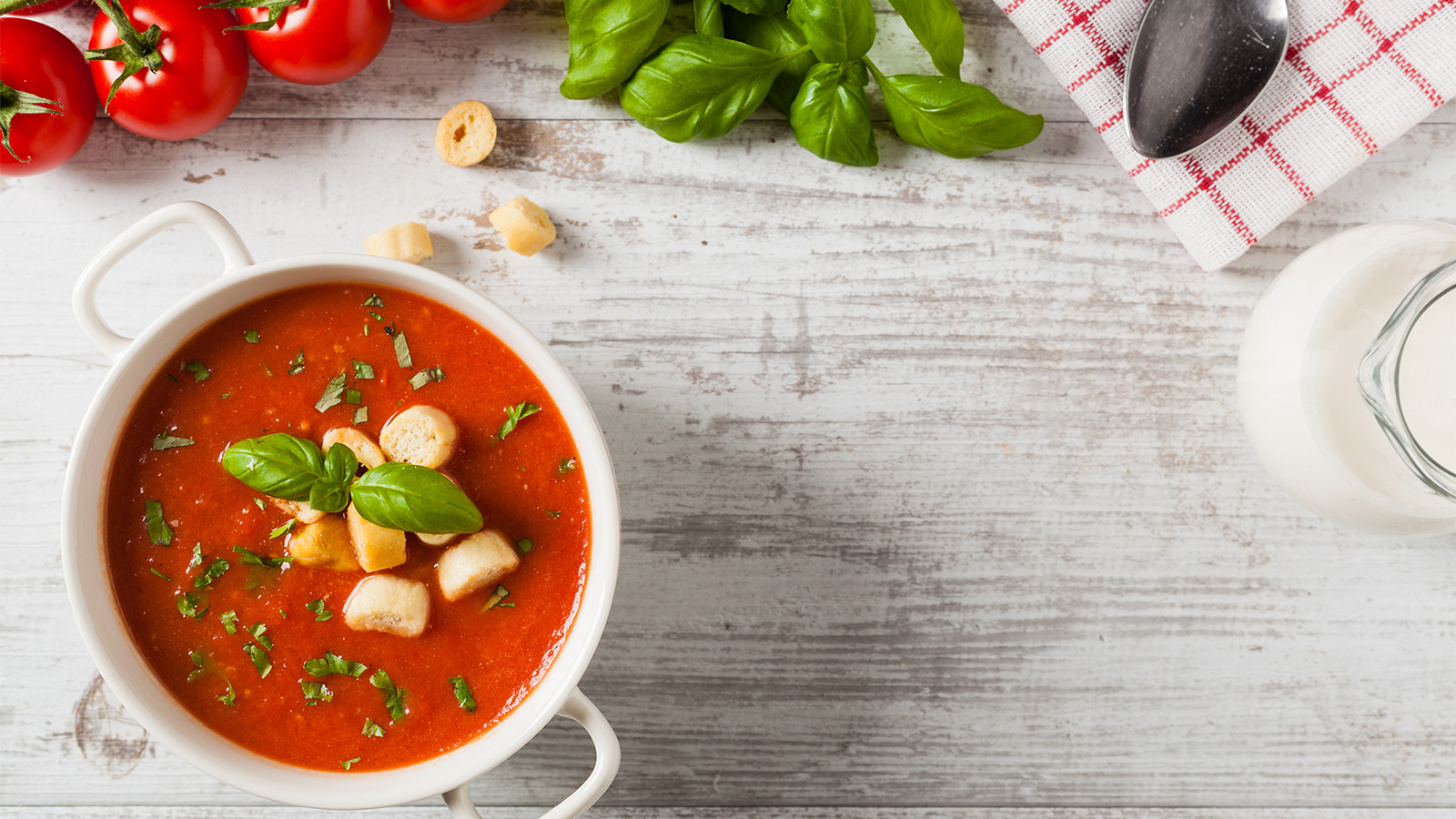A vibrant orange roasted red pepper soup crumbled with salty white feta cheese.