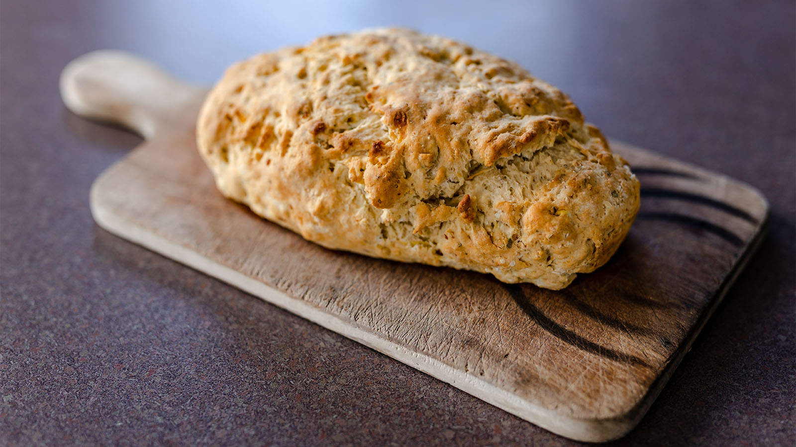 Traditional South African roosterkoek bread rolls grilled over open braai barbecue coals.