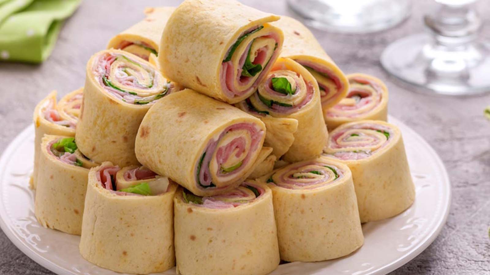 A beautiful rolled-up savoury or sweet roulade pancake sliced cleanly to show layers.