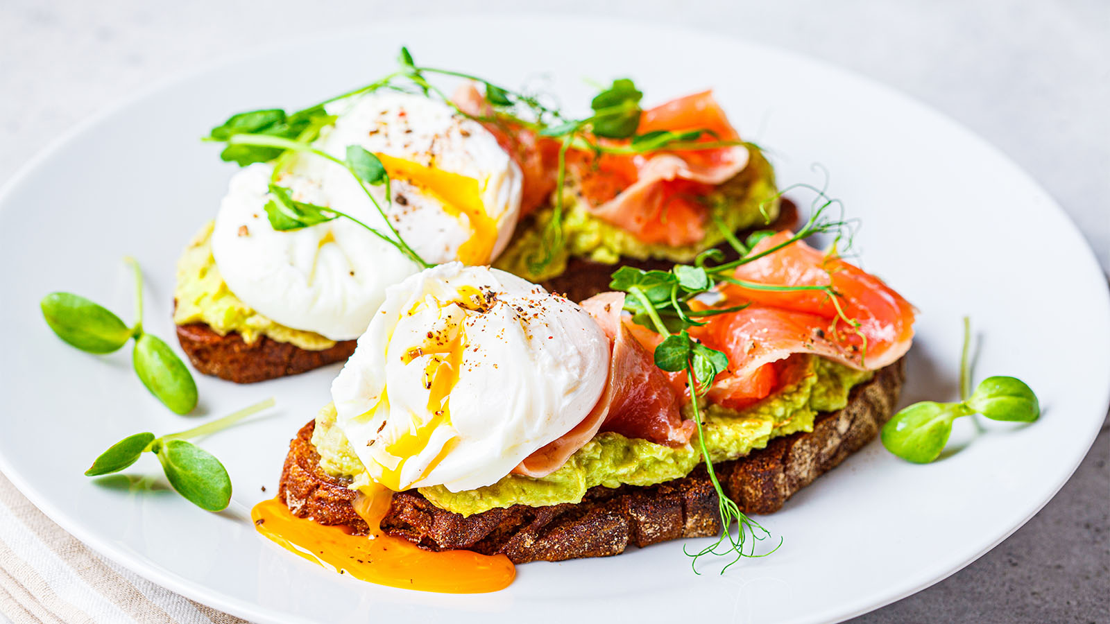 Thin slices of pink smoked salmon over fluffy scrambled eggs served on dense rye toast.