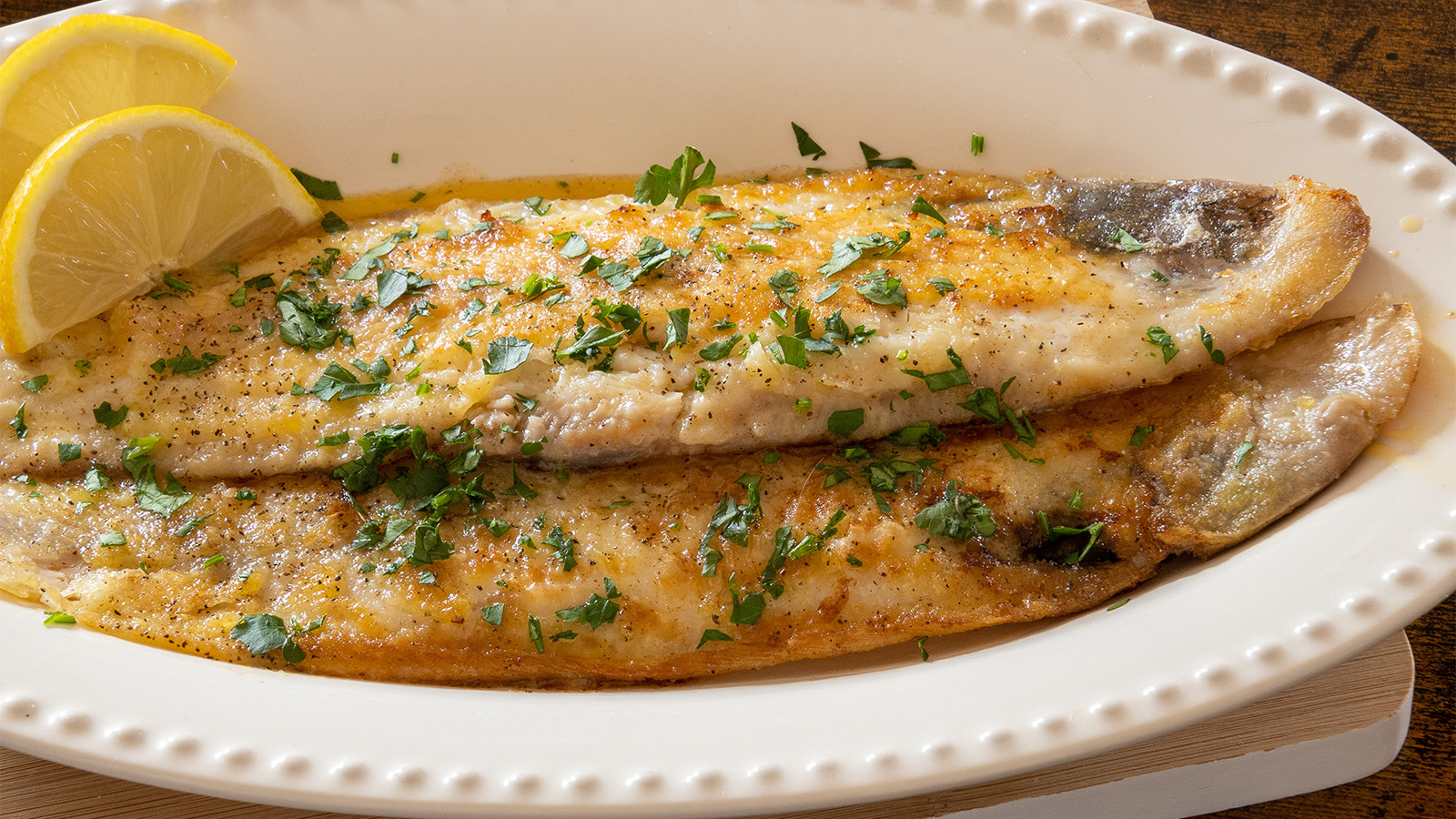 A classic French pan-fried delicate sole meuniere fish fillet in lemon butter sauce.