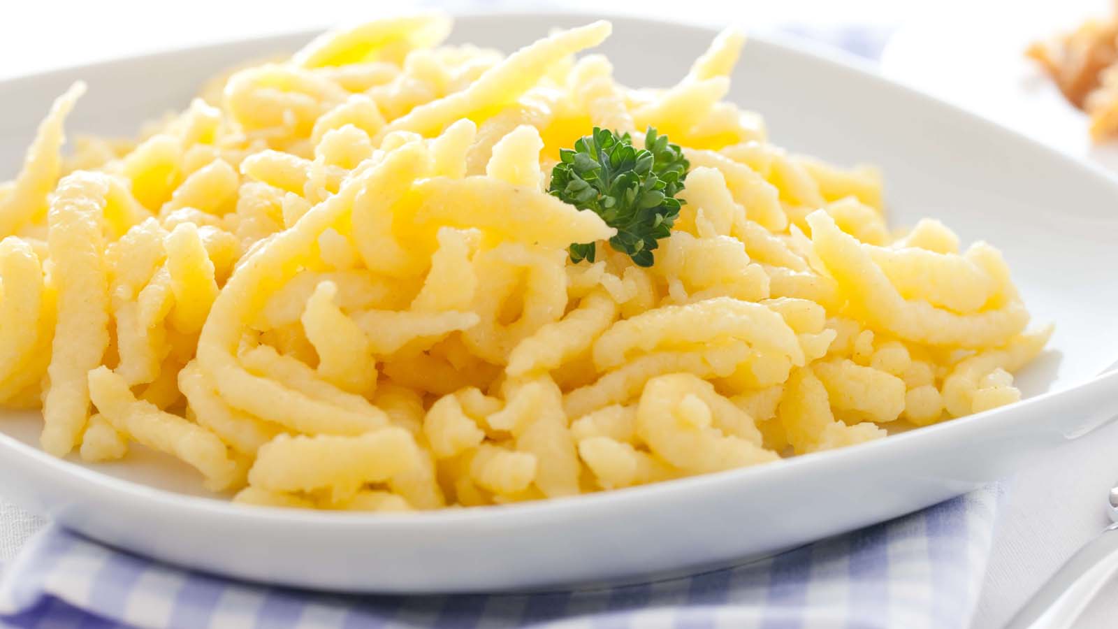 A bowl of traditional golden homemade German spaetzle egg noodles.