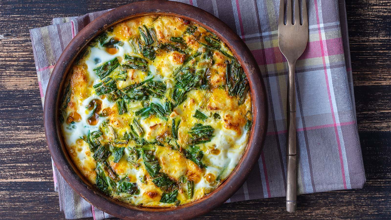A light folded egg omelette filled with healthy green spinach and crumbled feta cheese.