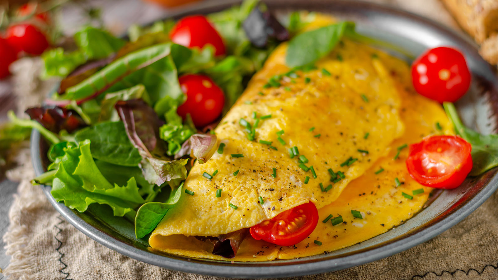A fluffy egg omelet filled with Mediterranean sun-dried tomatoes, basil, and feta cheese.