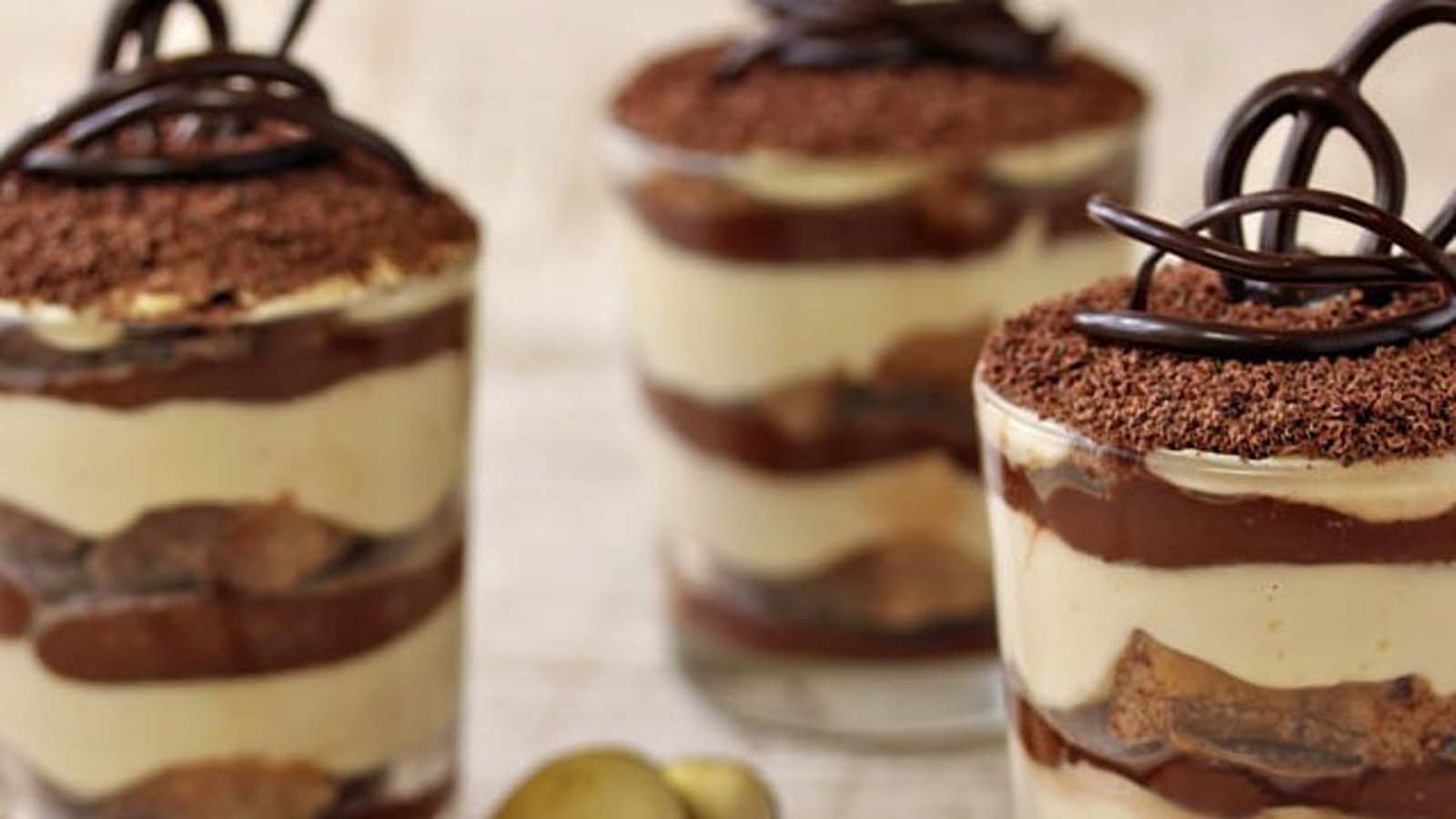 A traditional Italian classic tiramisu layered with espresso-soaked ladyfingers and cocoa powder.