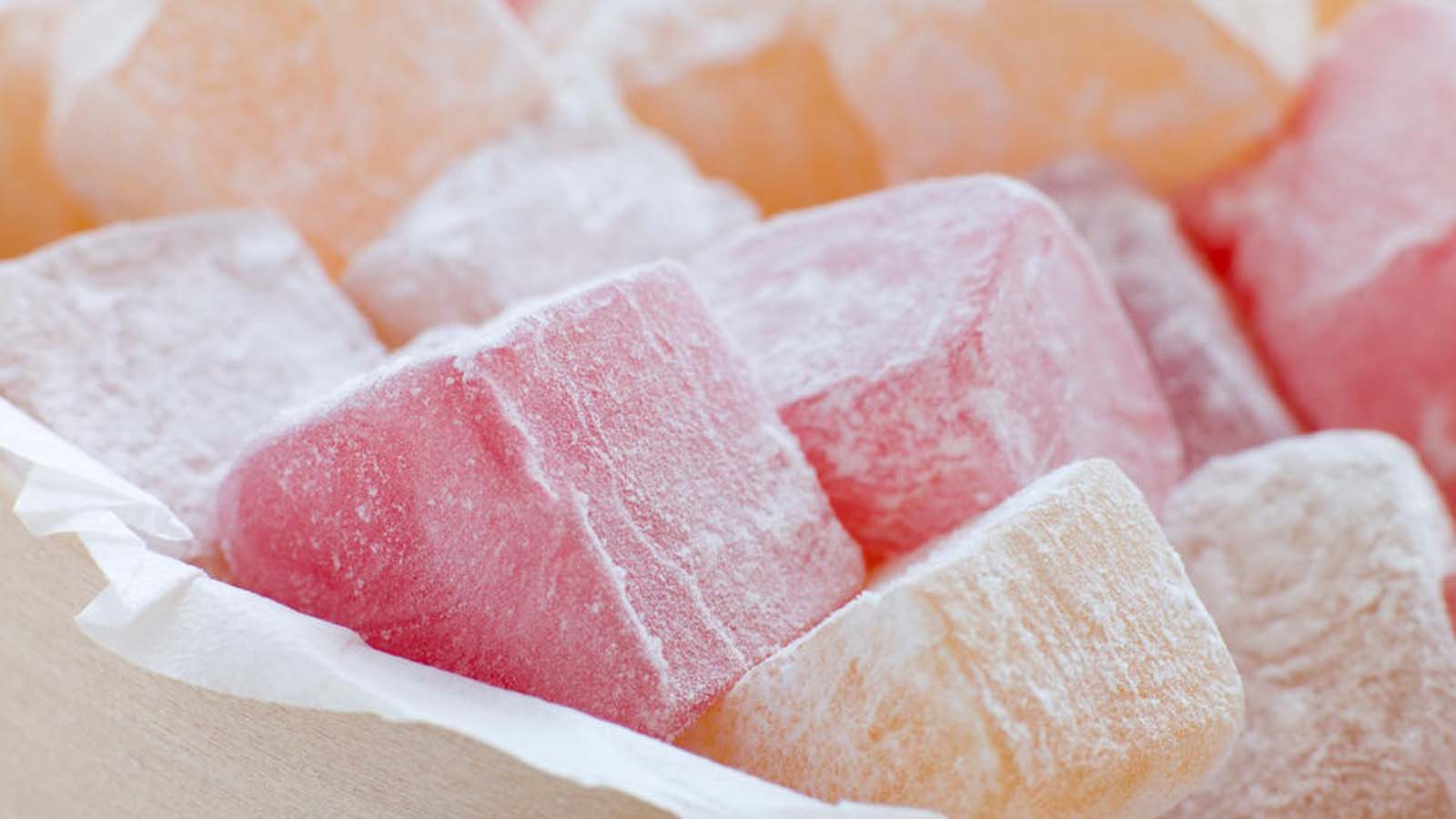 Soft, powdery pink cubes of traditional Turkish delight confectionary dusted with sugar.