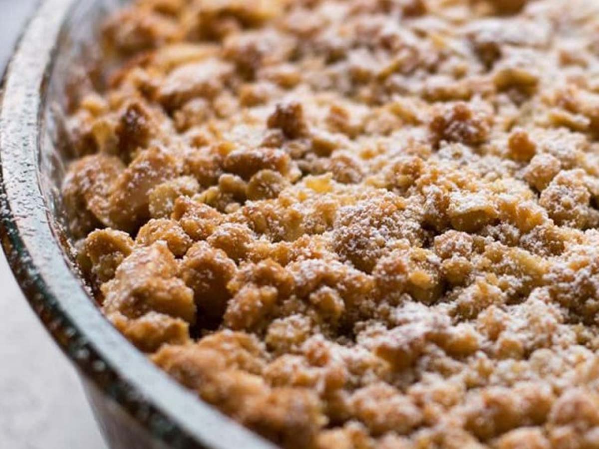 A warm baked apple crumble dessert with a golden, buttery oat topping.