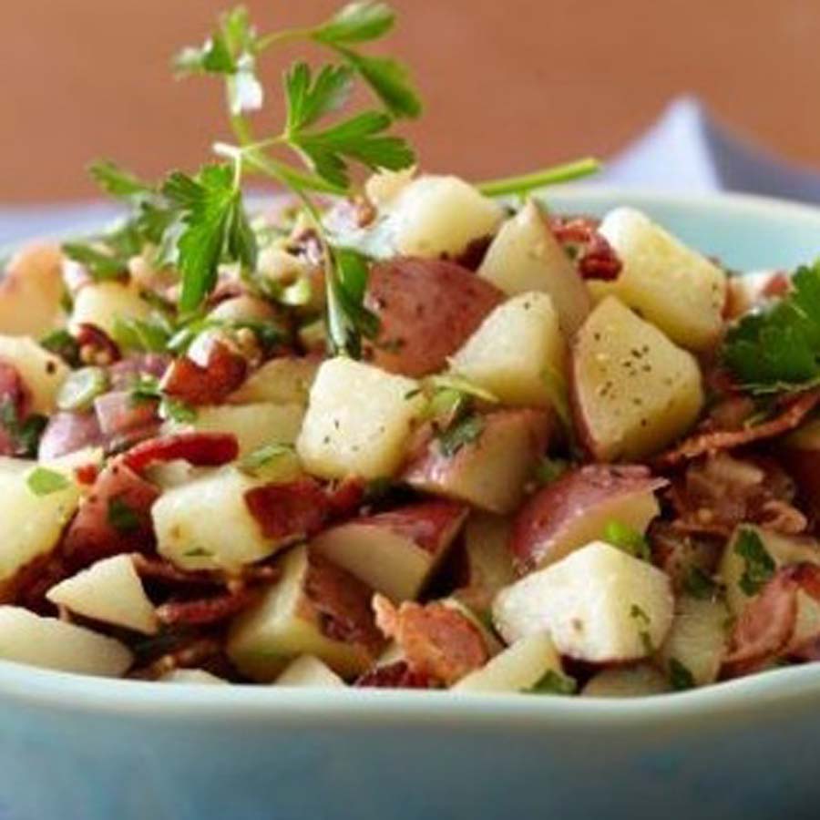 Uschi''s classic creamy potato salad mixed with fresh herbs and mayonnaise for a braai.