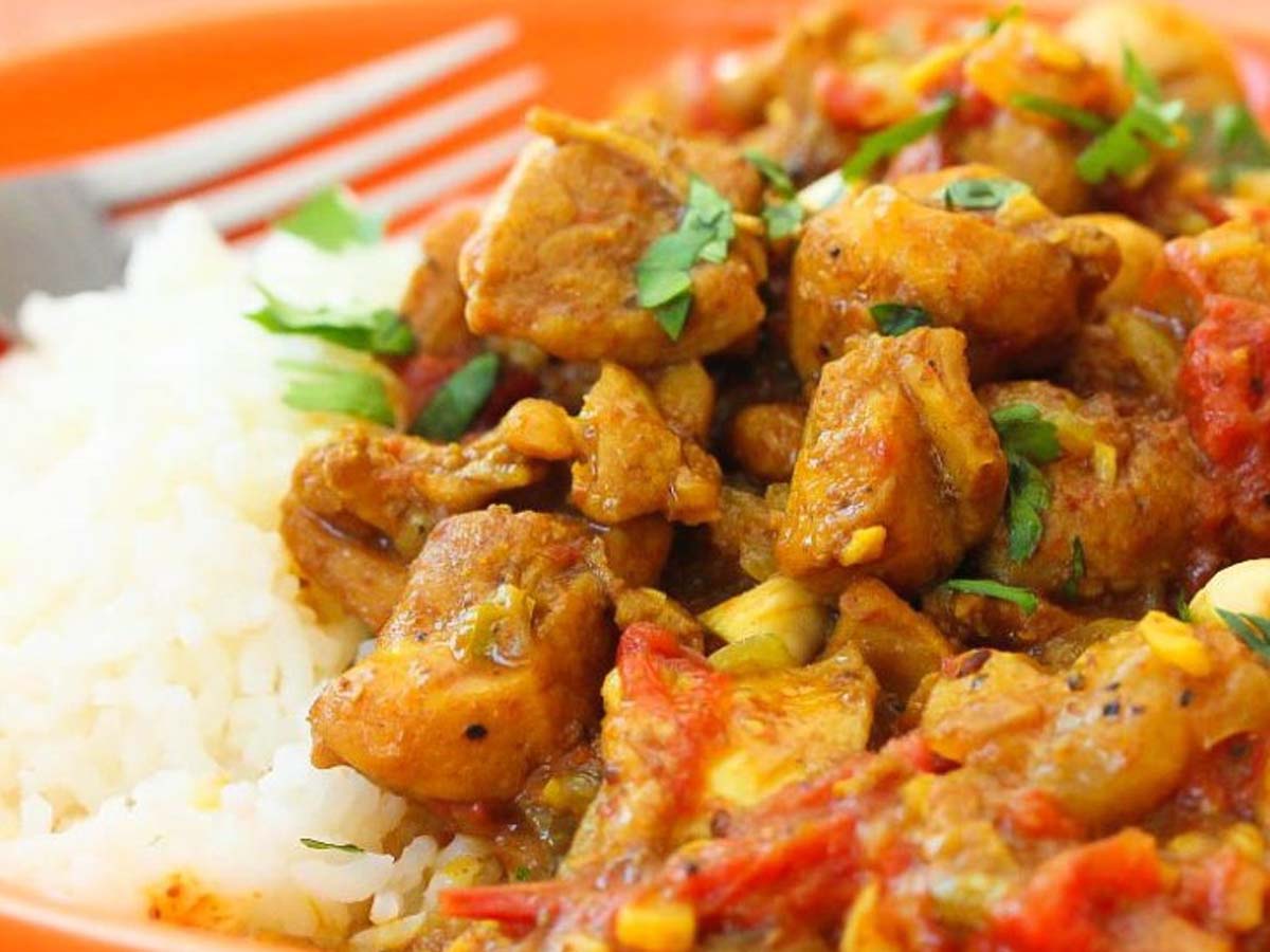 A fragrant, aromatic golden chicken curry simmering with deep spices.