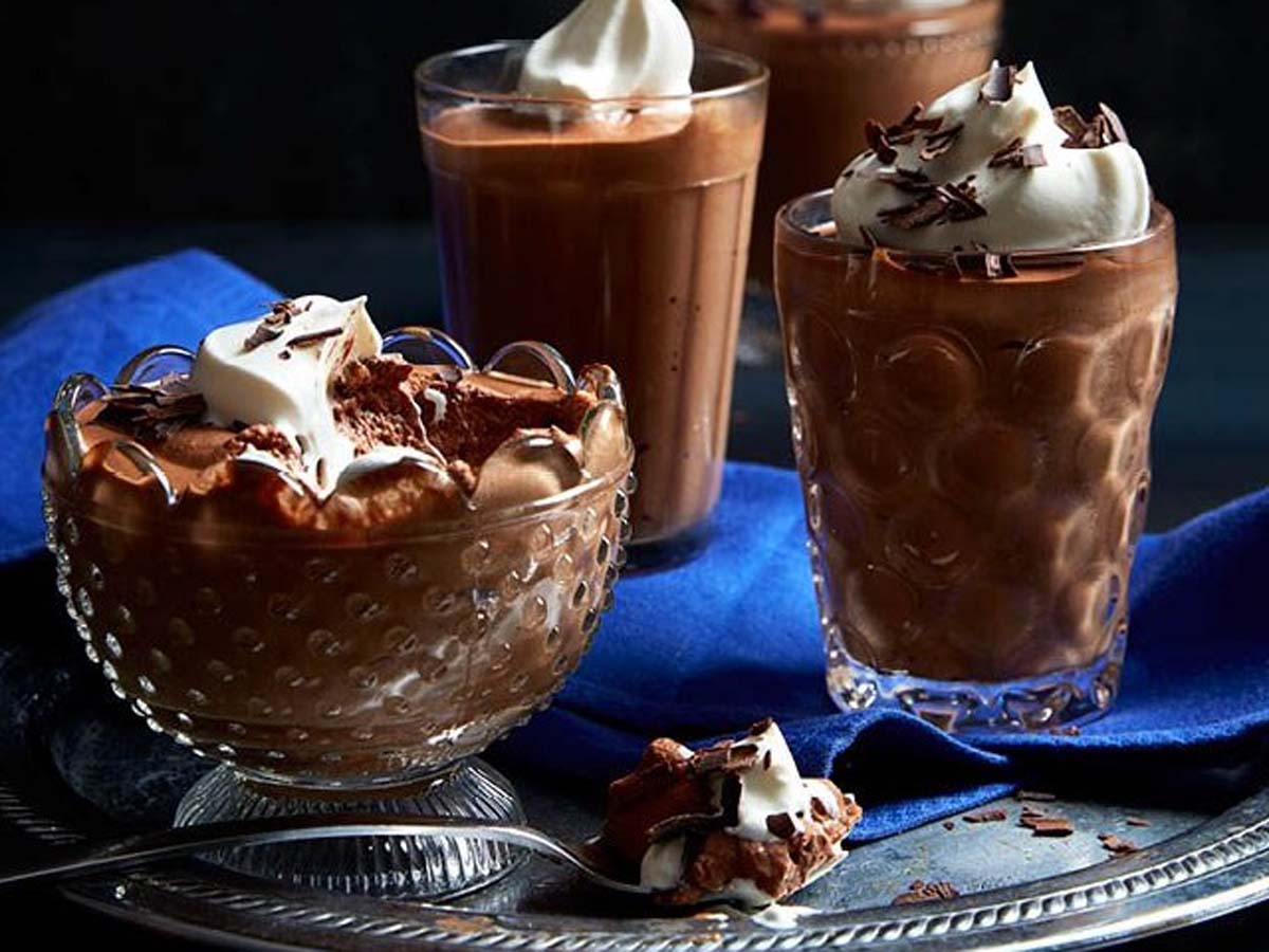 Light and airy chocolate mousse served in elegant glass cups topped with chocolate shavings.