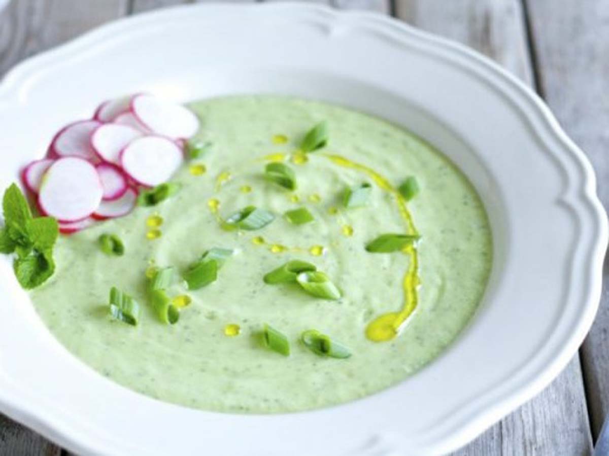 Chilled and refreshing cold cucumber and mint soup served in a porcelain bowl.